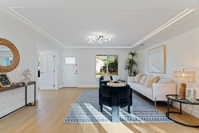 a view of a workspace with furniture and a potted plant