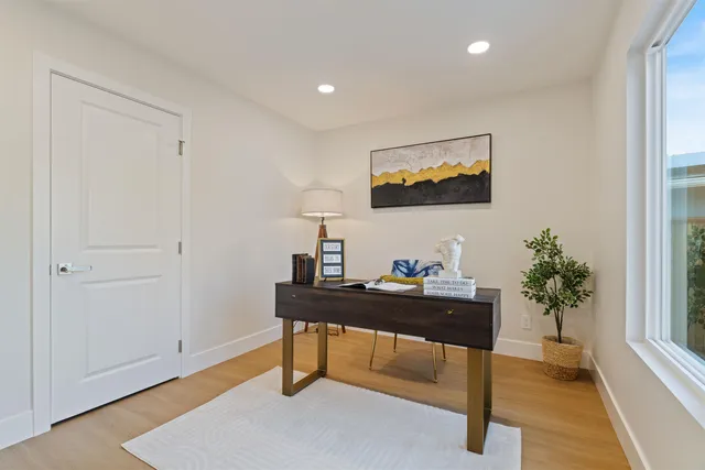 a view of a dining room with furniture a chandelier and wooden floor