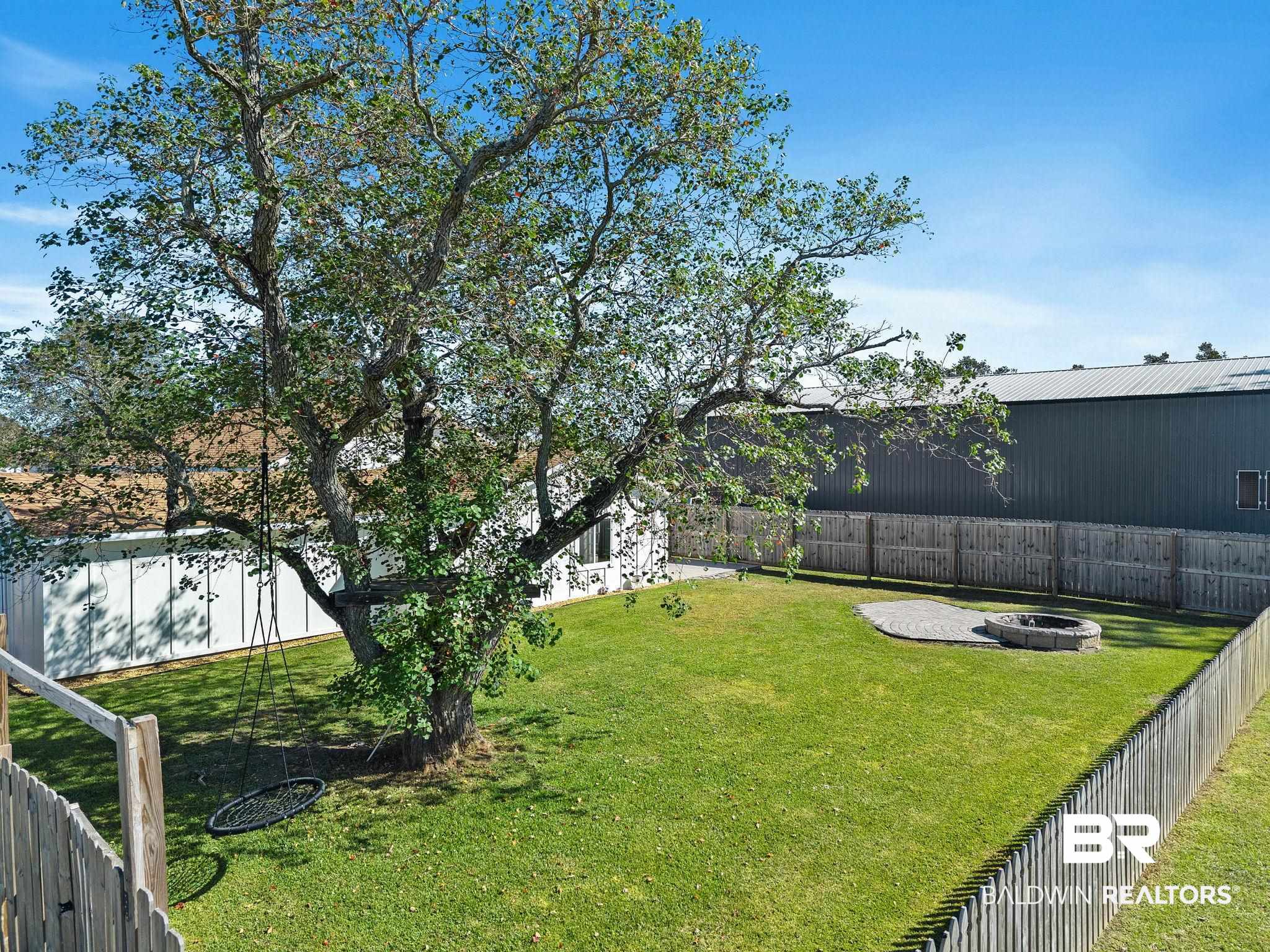 16796 Thompson Road Loxley, AL 36551 - Photo 56 of 93 Fenced backyard with a fire pit