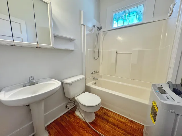 a bathroom with a sink a toilet and a bathtub