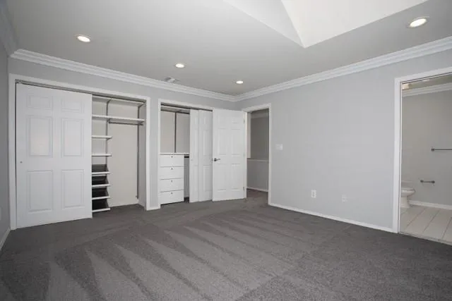 a view of an empty room with closet and entryway