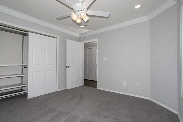 an empty room with a ceiling fan
