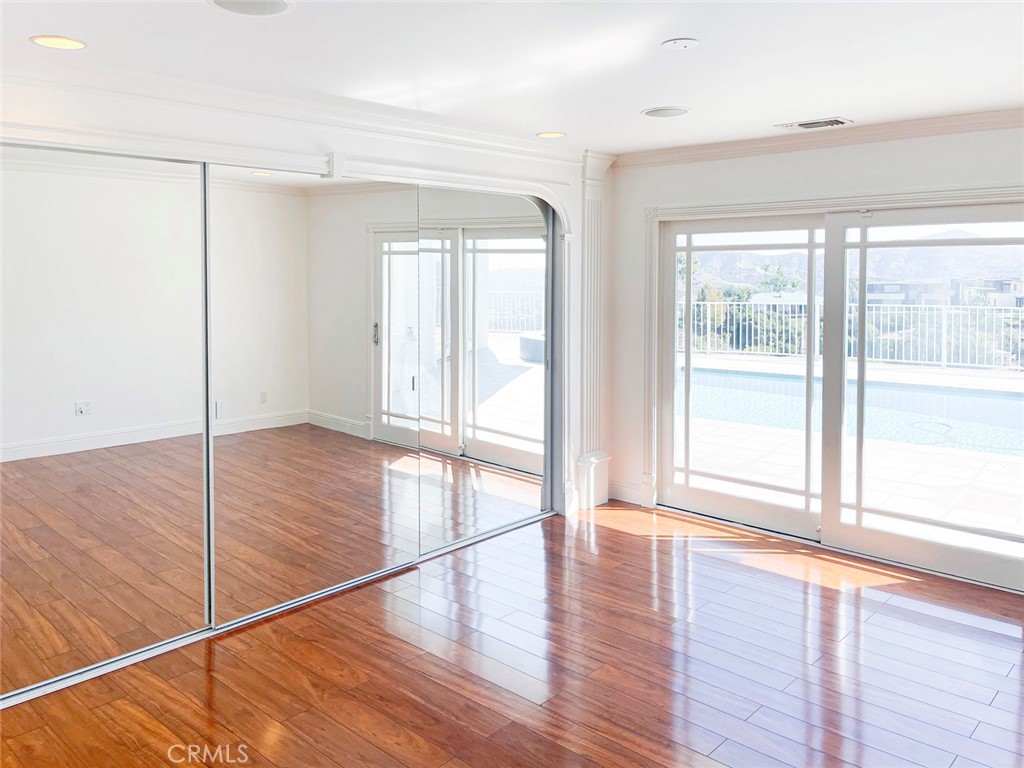 1981 Deermont Road Glendale, CA 91207 - Photo 32 of 49 a view of an empty room with wooden floor and a window