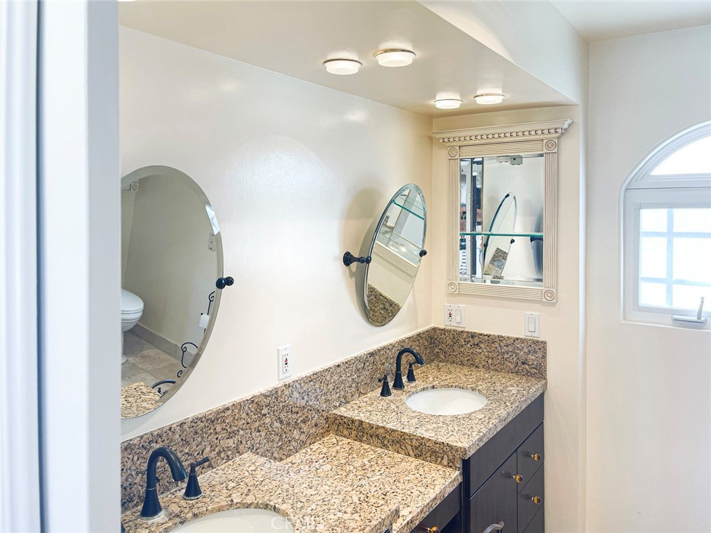 1981 Deermont Road Glendale, CA 91207 - Photo 37 of 49 a bathroom with a granite countertop sink and a mirror