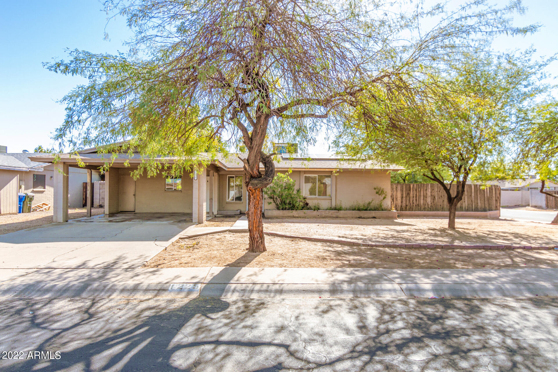 1225 West Halstead Drive Phoenix, AZ 85023 - Photo 1 of 19 a view of a yard and a house in the background