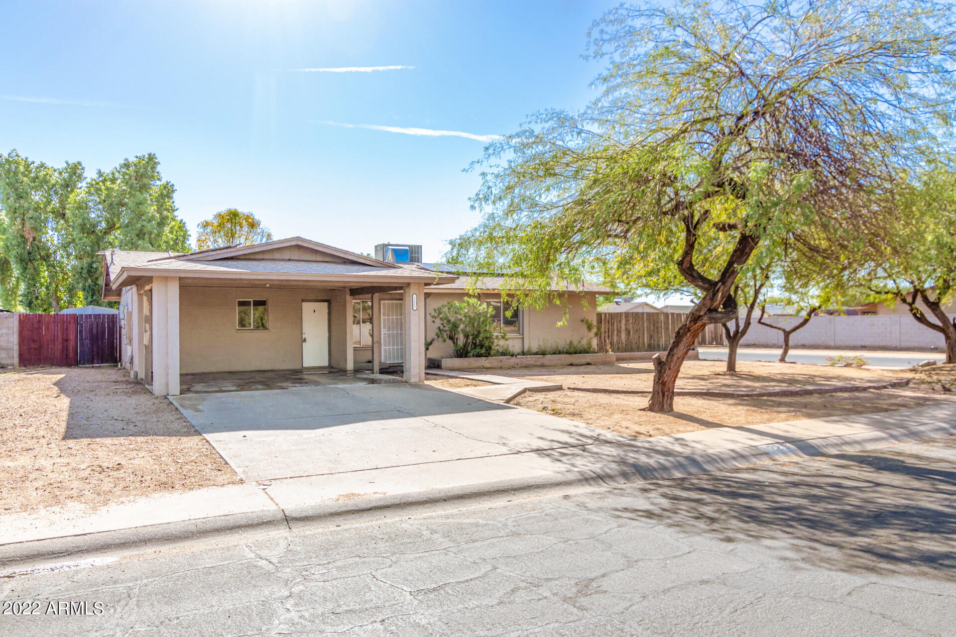 1225 West Halstead Drive Phoenix, AZ 85023 - Photo 2 of 19 a front view of a house with a yard and a garage