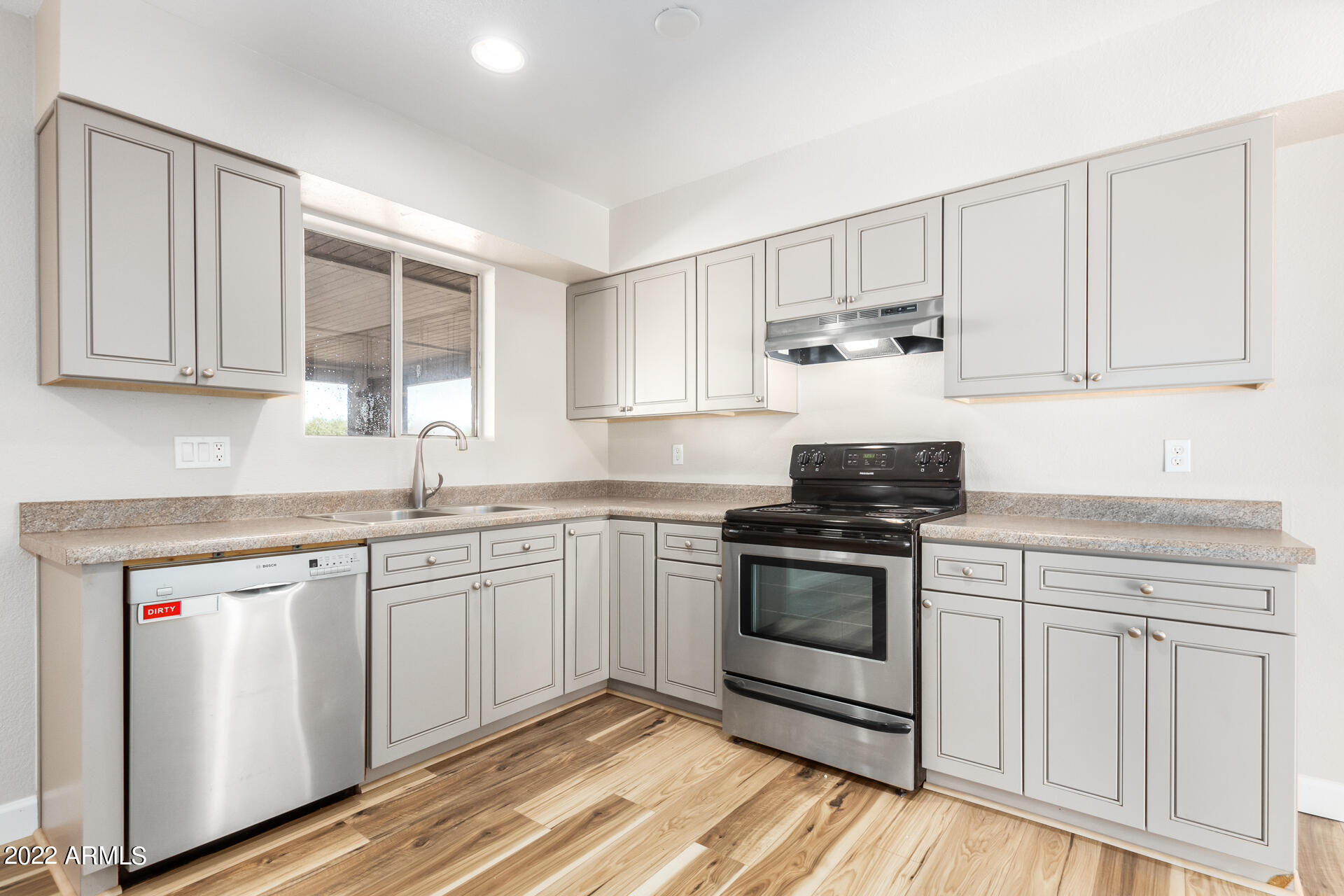 1225 West Halstead Drive Phoenix, AZ 85023 - Photo 4 of 19 a kitchen with cabinets appliances and a sink