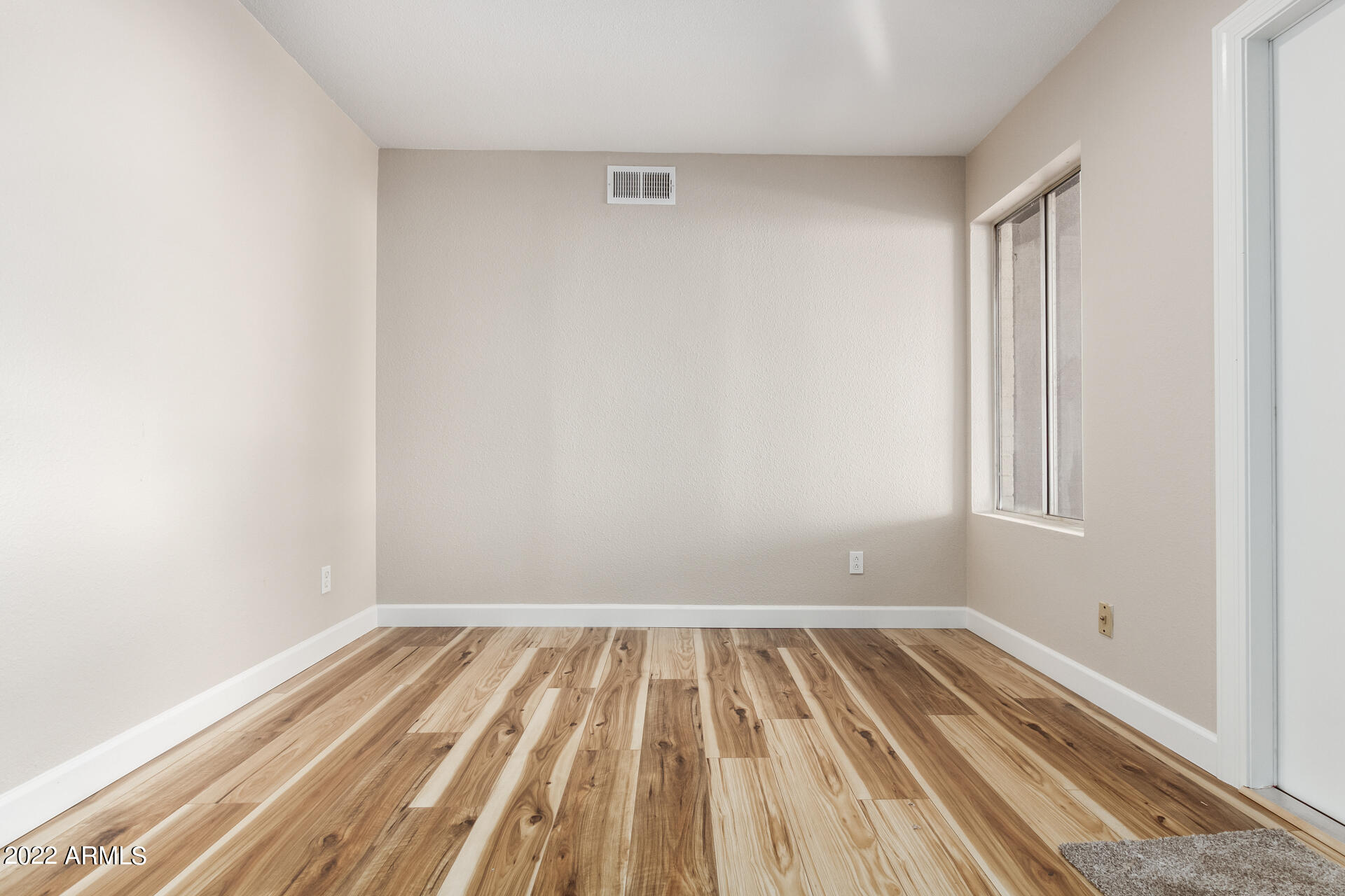 1225 West Halstead Drive Phoenix, AZ 85023 - Photo 9 of 19 a view of a room with wooden floor and small window