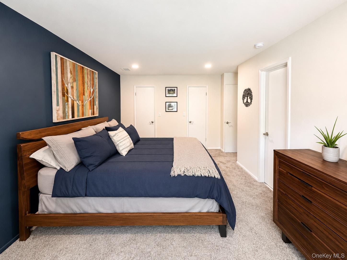 201 Birchwood Road, Unit 201 Coram, NY 11727 - Photo 14 of 27 a bedroom with a bed and a potted plant