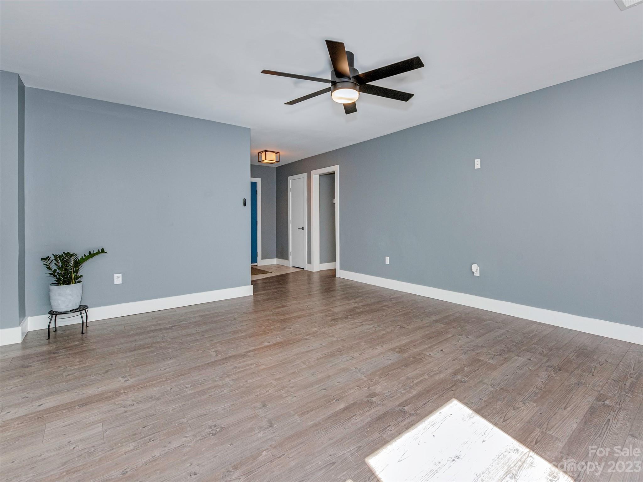 9613 Watergate Road Charlotte, NC 28270 - Photo 14 of 33 a view of a livingroom with a hardwood floor and a ceiling fan