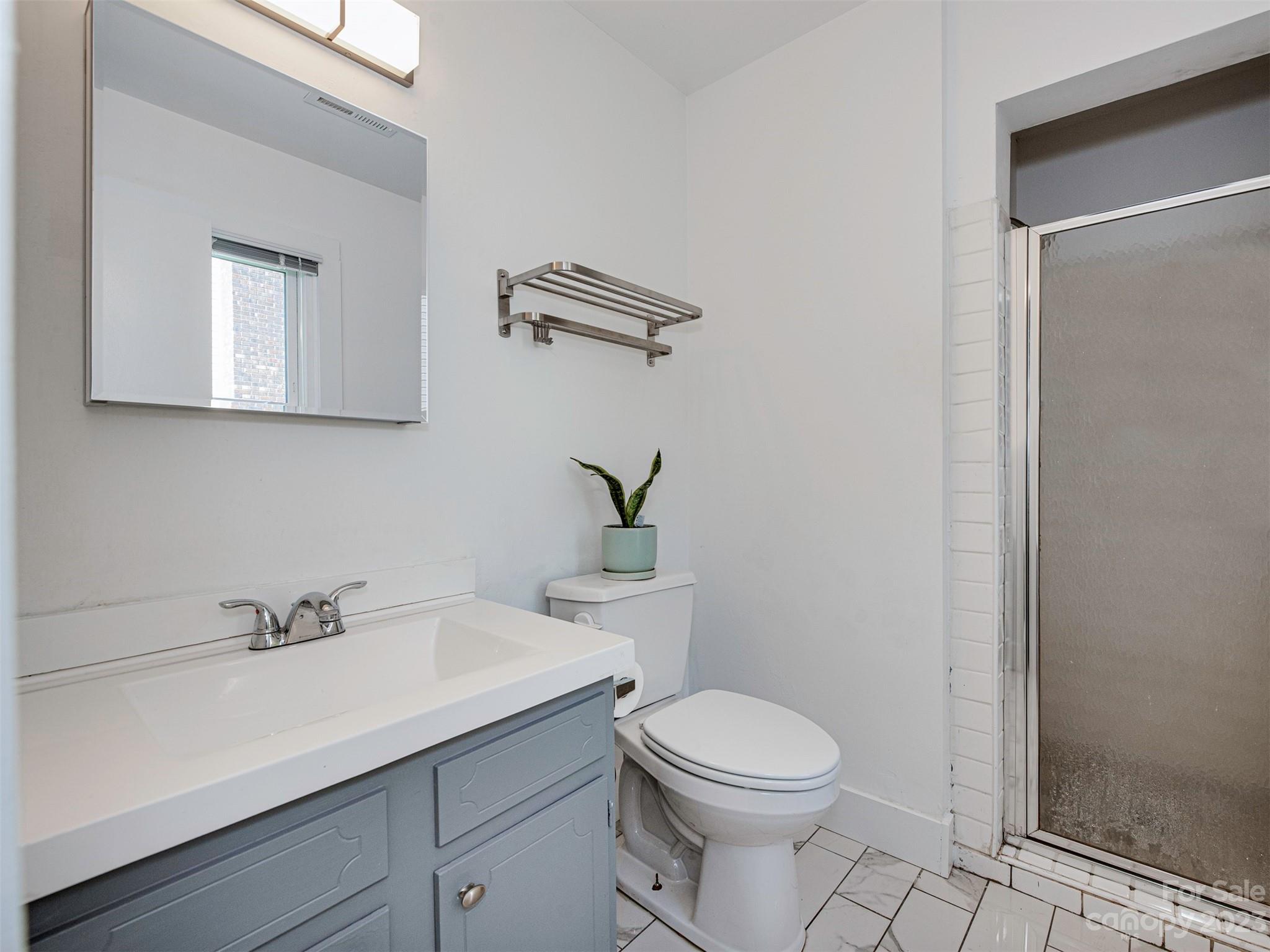 9613 Watergate Road Charlotte, NC 28270 - Photo 18 of 33 a bathroom with a sink a toilet and shower