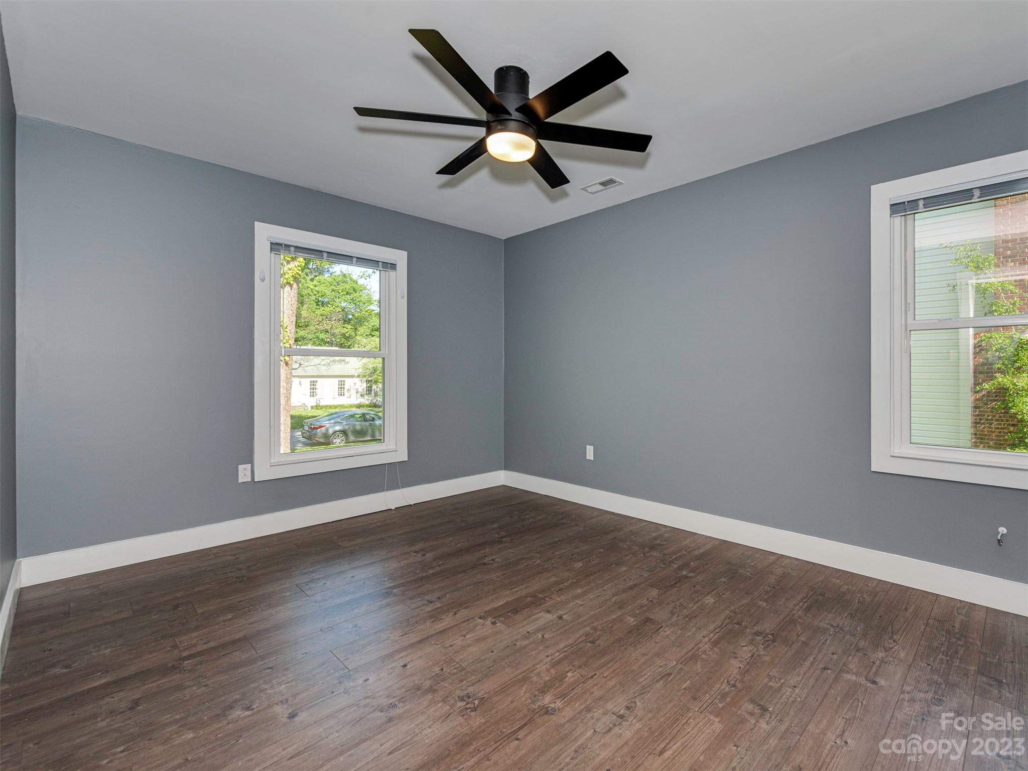 9613 Watergate Road Charlotte, NC 28270 - Photo 22 of 33 an empty room with wooden floor and windows