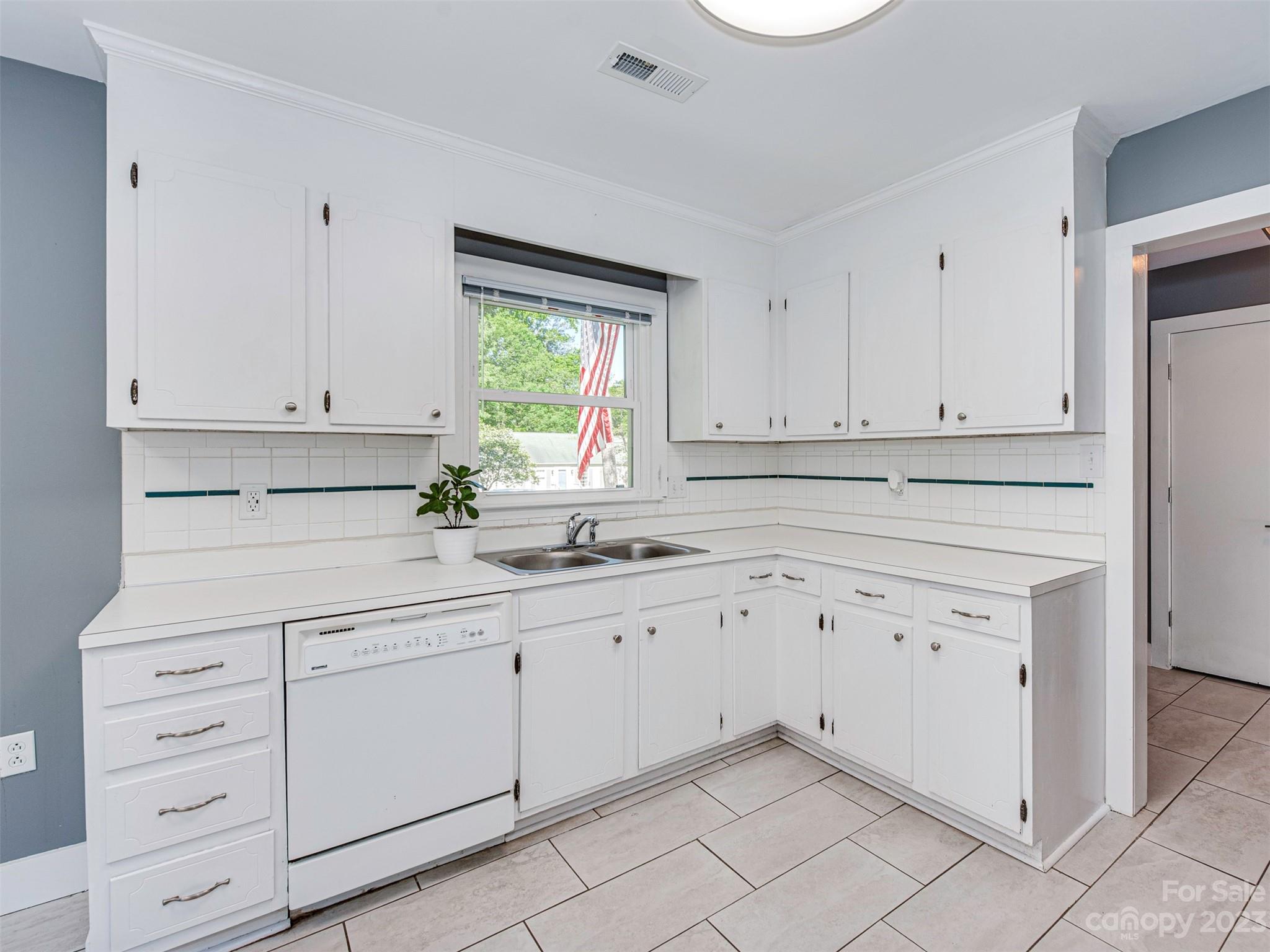 9613 Watergate Road Charlotte, NC 28270 - Photo 4 of 33 a kitchen with granite countertop white cabinets and white appliances