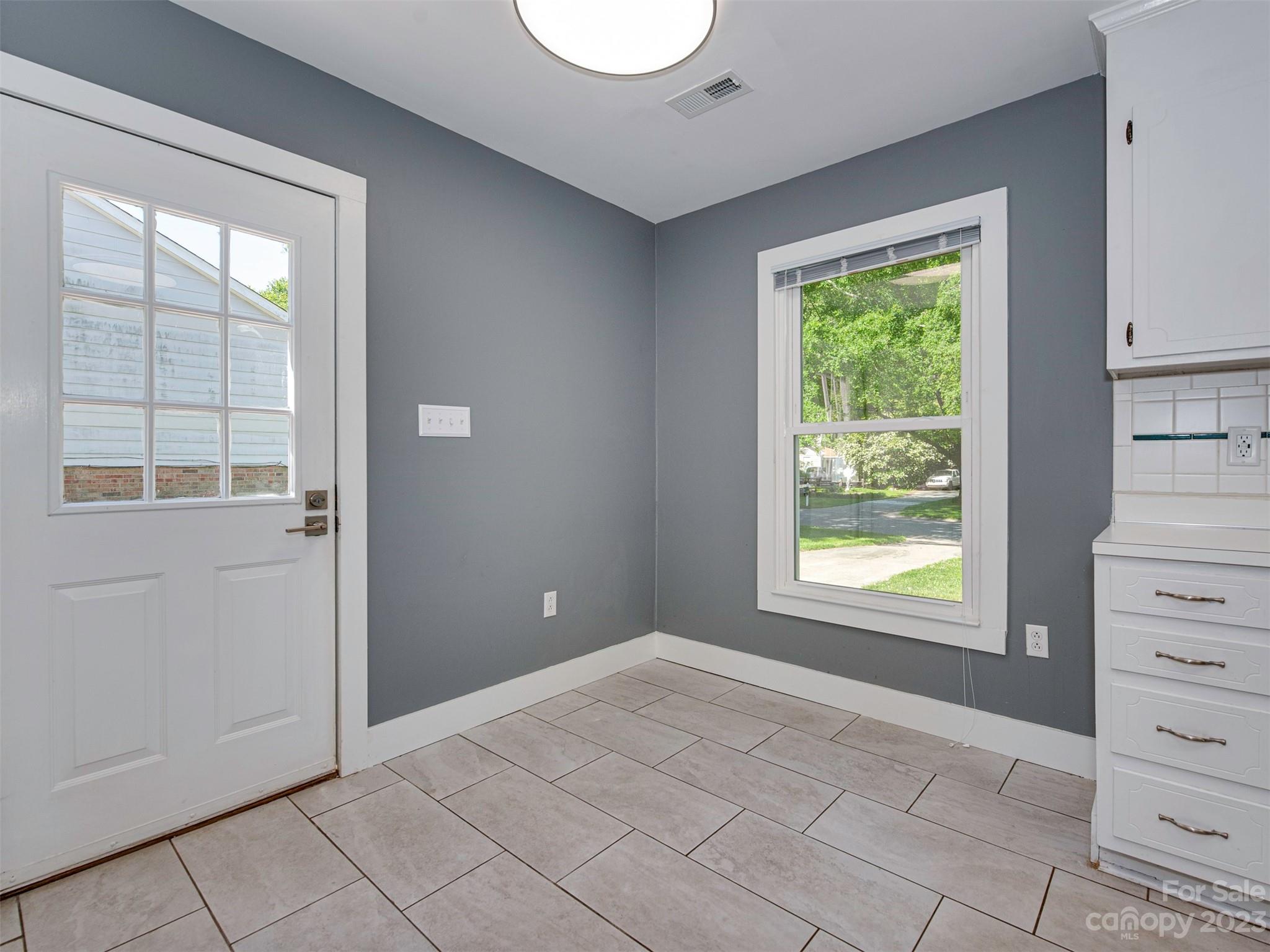 9613 Watergate Road Charlotte, NC 28270 - Photo 7 of 33 an empty room with a window and cabinet
