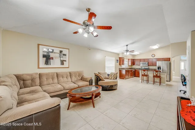 a living room with furniture and kitchen view