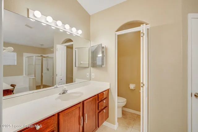 a bathroom with a double vanity sink toilet and shower