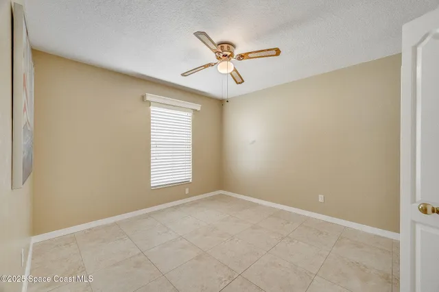 a view of a room with a ceiling fan and a window