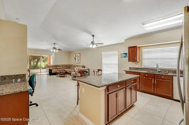 a kitchen with a stove a sink dishwasher and a refrigerator