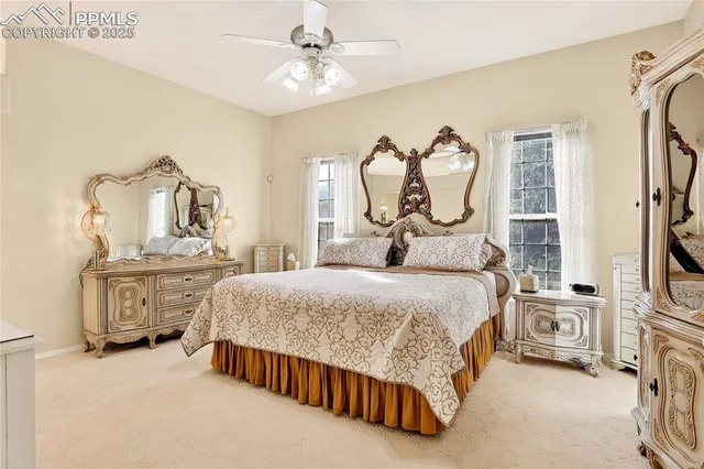 a bedroom with a bed dresser and a flat tv screen