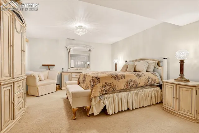 a bedroom with a white bed and white cabinets
