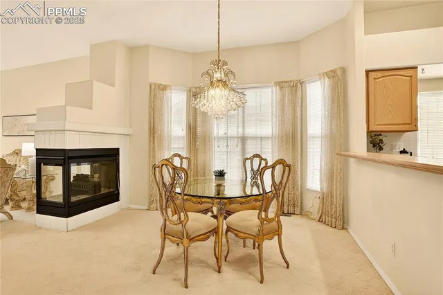 a dining room with furniture and a fireplace