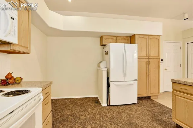 a kitchen with a refrigerator and a stove