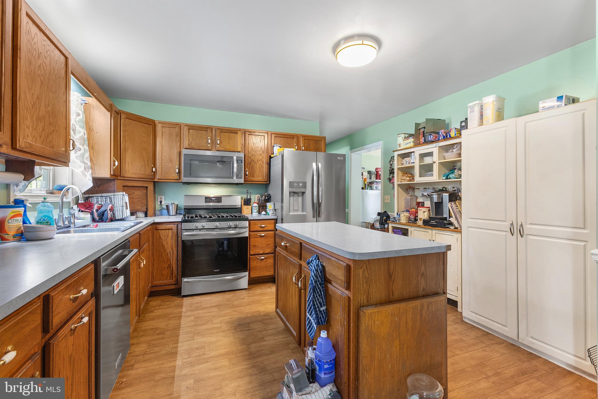 7112 East New Market Ellwood Road Hurlock, MD 21643 - Photo 10 of 41 a kitchen with stainless steel appliances a stove refrigerator sink and a microwave