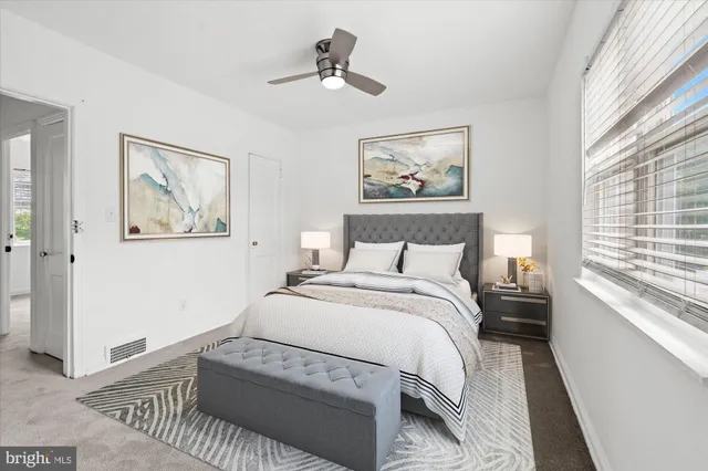 a bedroom with a large bed and a window
