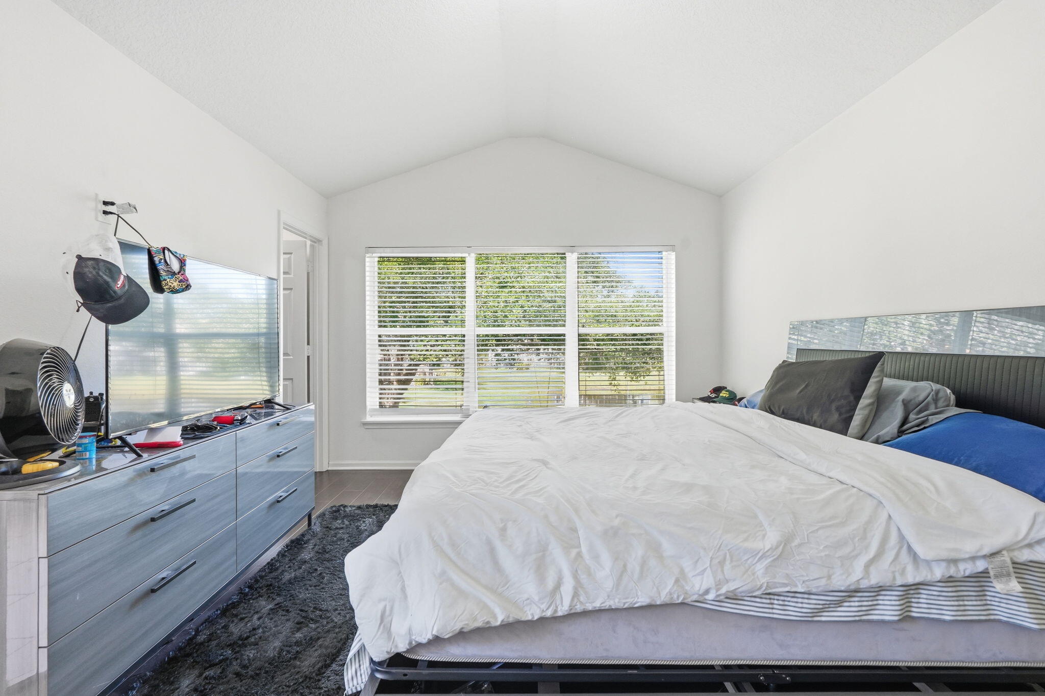 1086 Woodfield Road Greenacres, FL 33415 - Photo 14 of 32 a large white bed in a bedroom next to a window