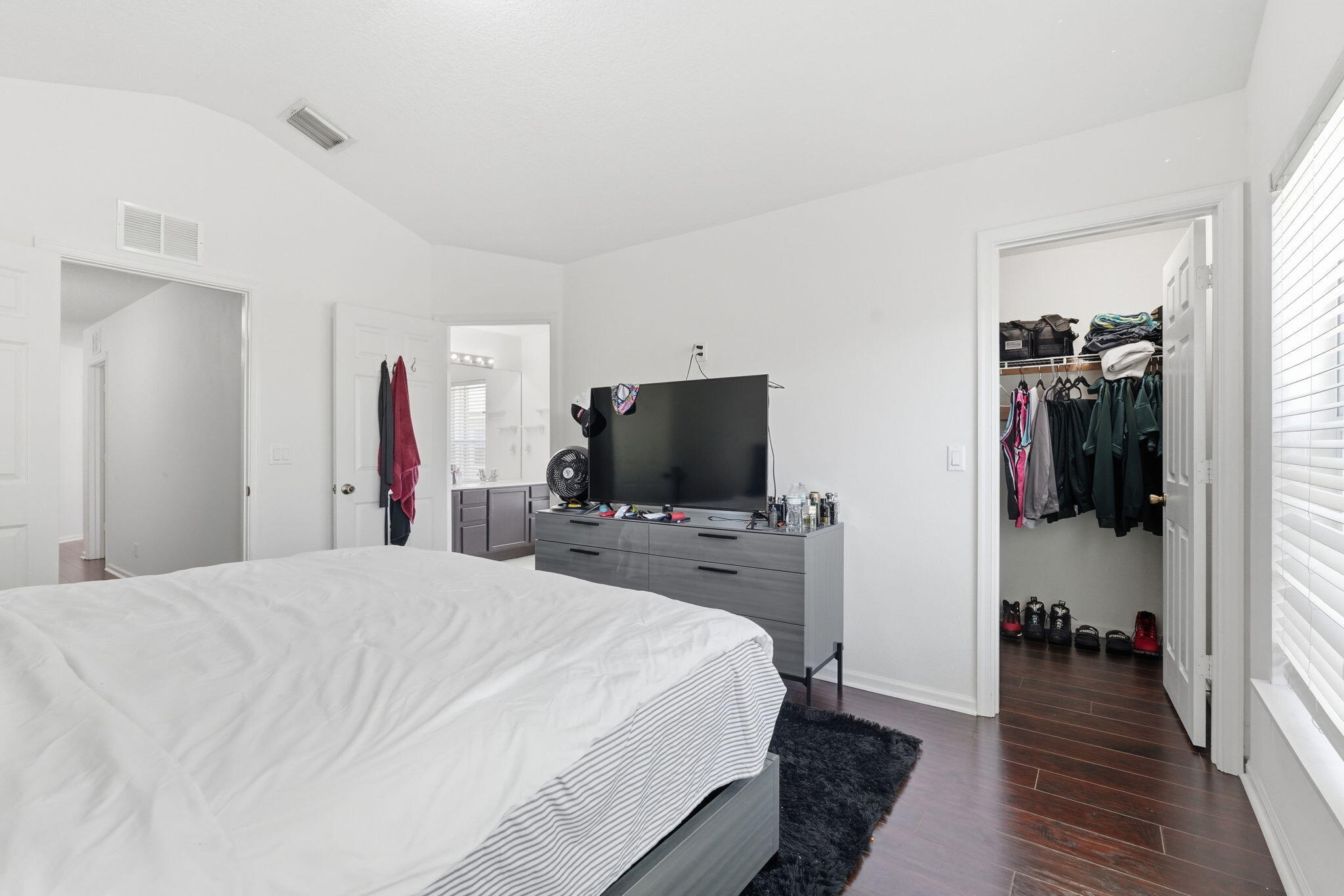 1086 Woodfield Road Greenacres, FL 33415 - Photo 15 of 32 a bedroom with a bed and a flat screen tv