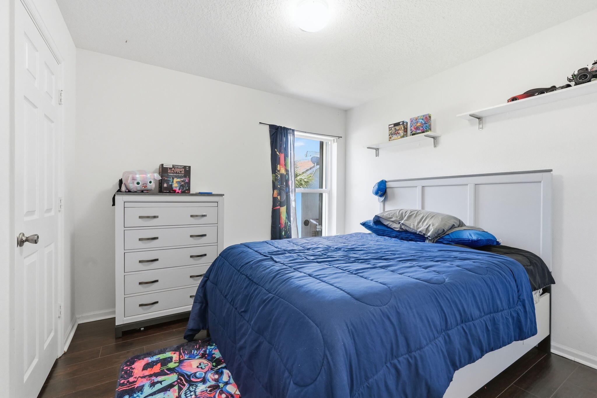 1086 Woodfield Road Greenacres, FL 33415 - Photo 18 of 32 a bedroom with a bed and a dresser