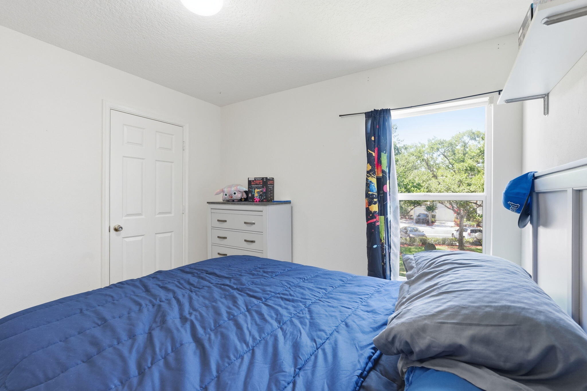 1086 Woodfield Road Greenacres, FL 33415 - Photo 19 of 32 a bedroom with a bed and a window