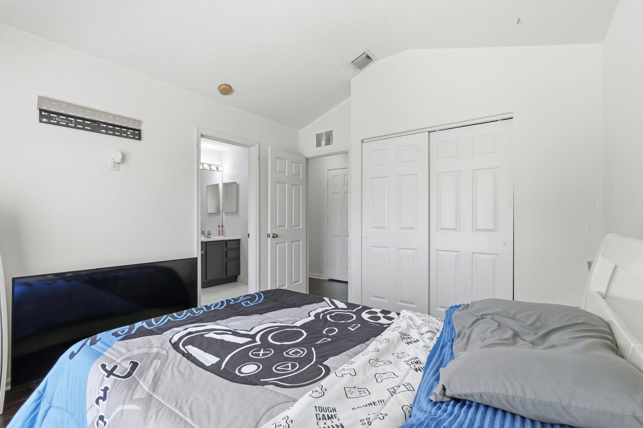 1086 Woodfield Road Greenacres, FL 33415 - Photo 22 of 32 a bedroom with a bed and a dresser