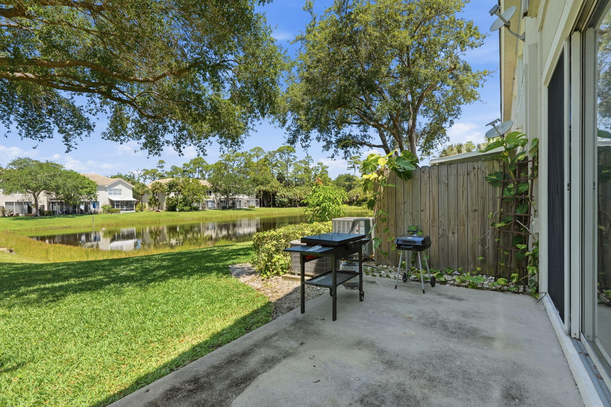 1086 Woodfield Road Greenacres, FL 33415 - Photo 26 of 32 a view of a chair and table in the garden