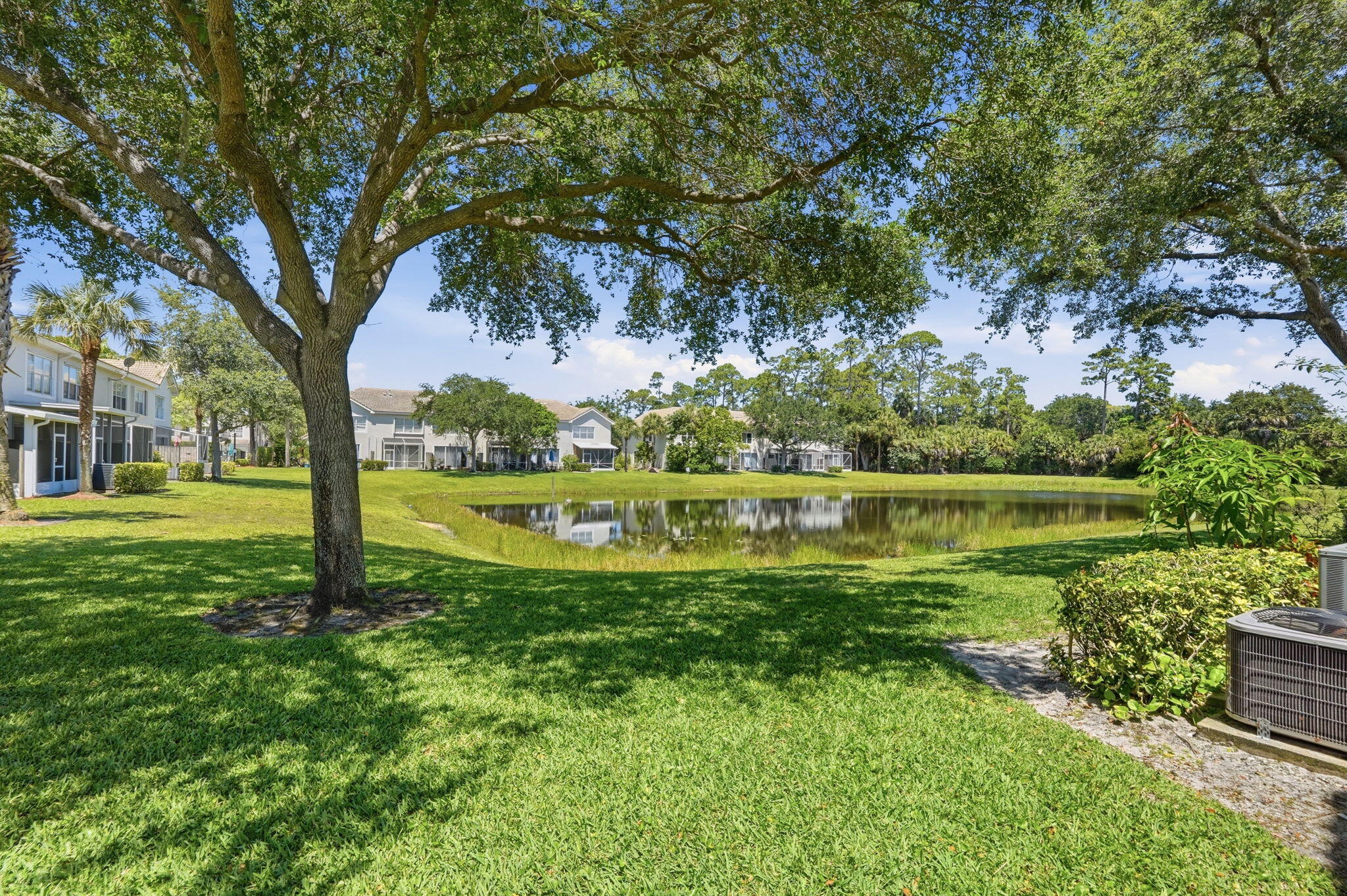 1086 Woodfield Road Greenacres, FL 33415 - Photo 27 of 32 a view of a garden with a lake