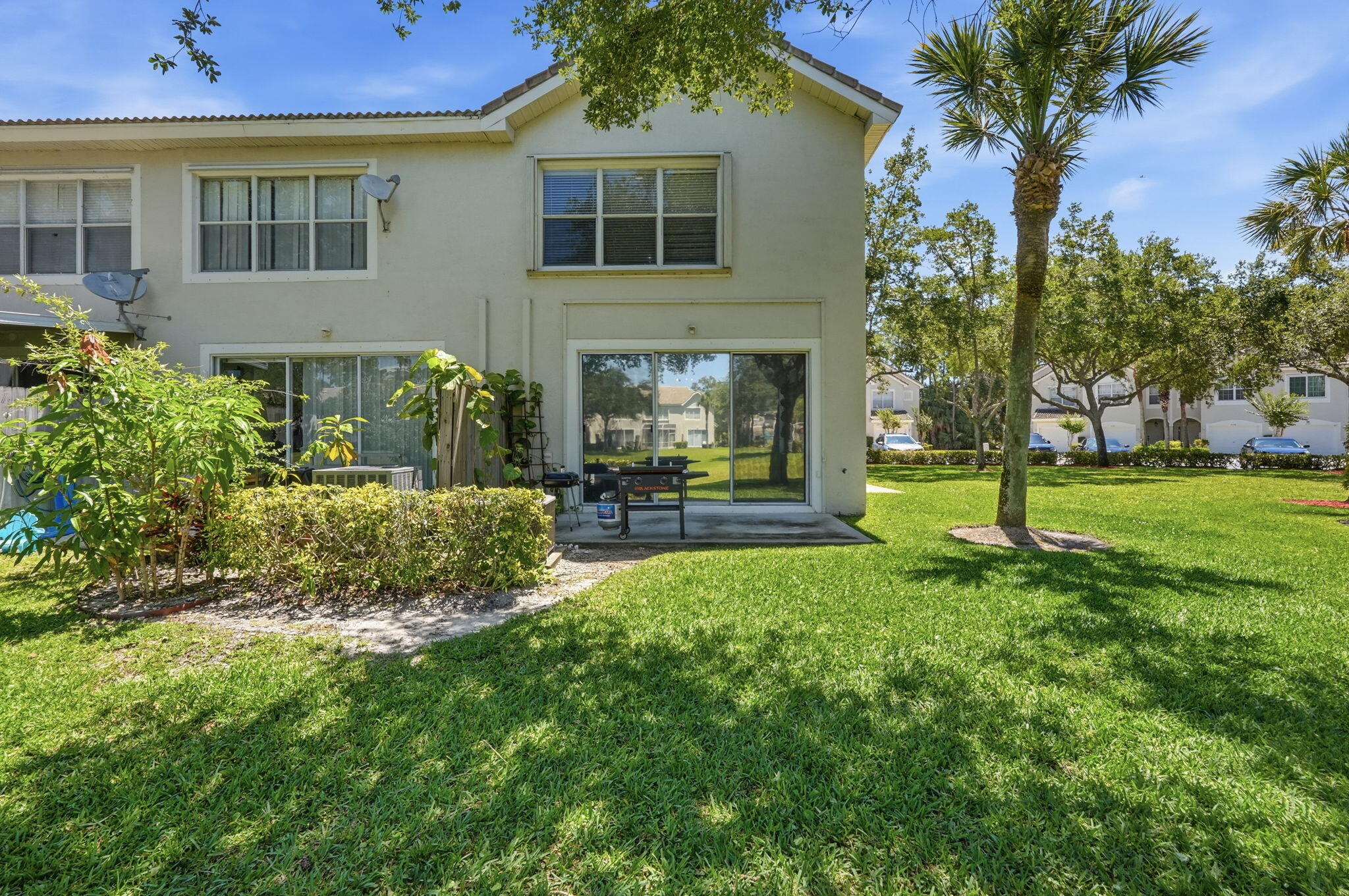 1086 Woodfield Road Greenacres, FL 33415 - Photo 28 of 32 a front view of a house with garden