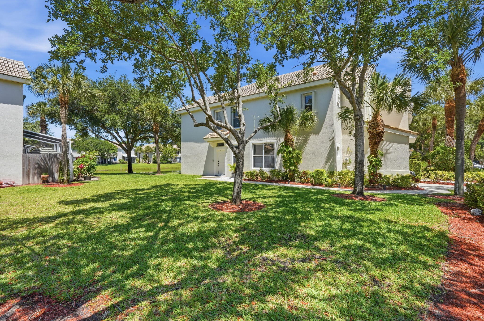 1086 Woodfield Road Greenacres, FL 33415 - Photo 29 of 32 a front view of a house with a yard