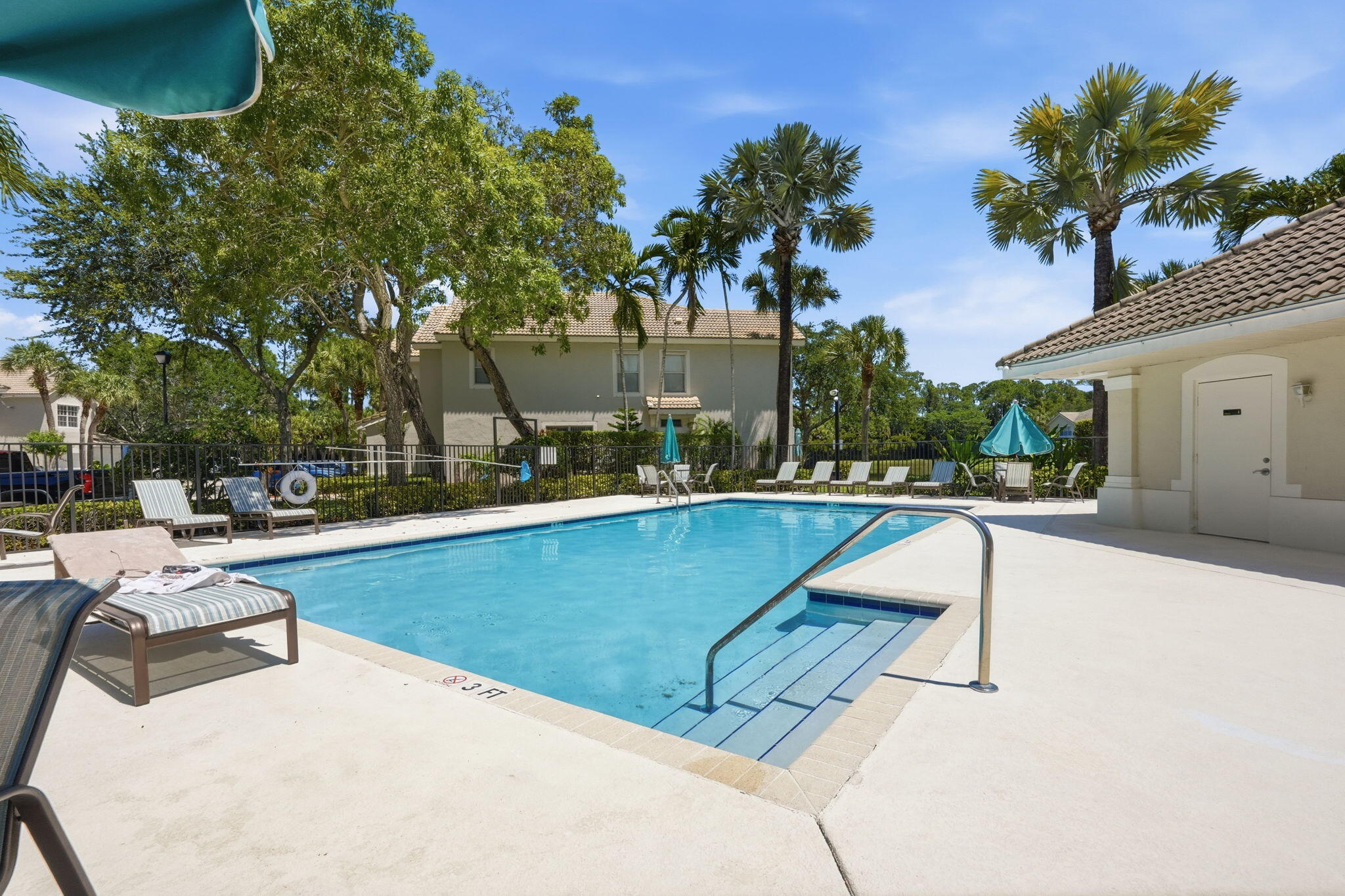 1086 Woodfield Road Greenacres, FL 33415 - Photo 30 of 32 a view of swimming pool with outdoor seating and plants