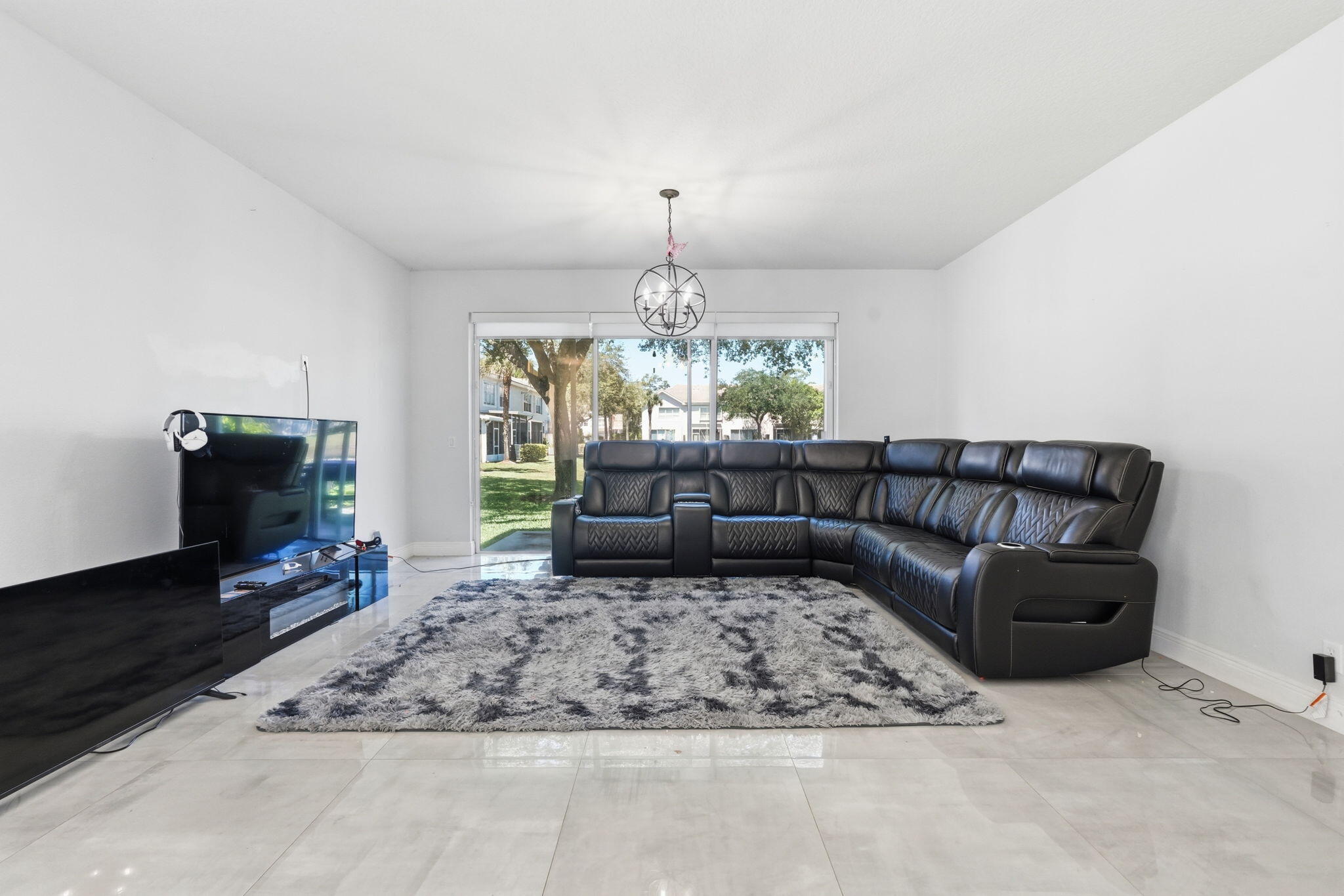 1086 Woodfield Road Greenacres, FL 33415 - Photo 5 of 32 a living room with furniture and a fireplace