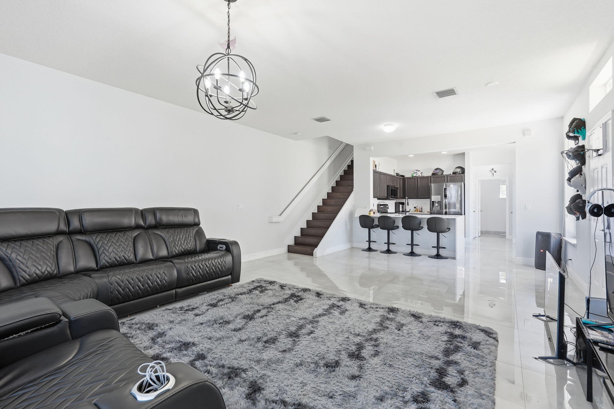 1086 Woodfield Road Greenacres, FL 33415 - Photo 6 of 32 a living room with furniture and a table