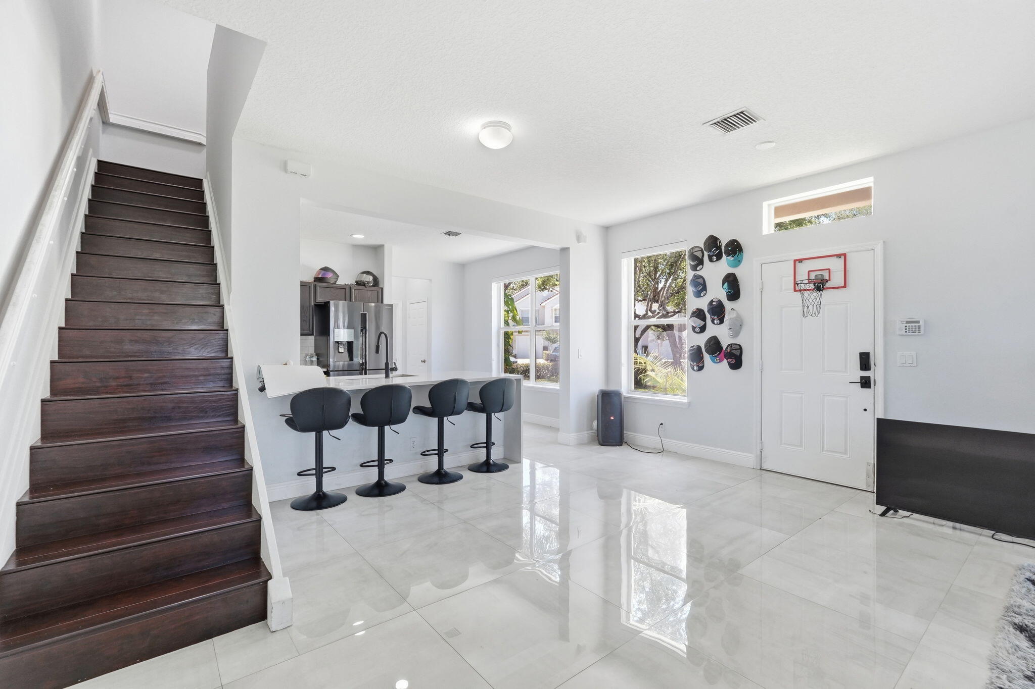 1086 Woodfield Road Greenacres, FL 33415 - Photo 7 of 32 a living room with furniture and wooden floor