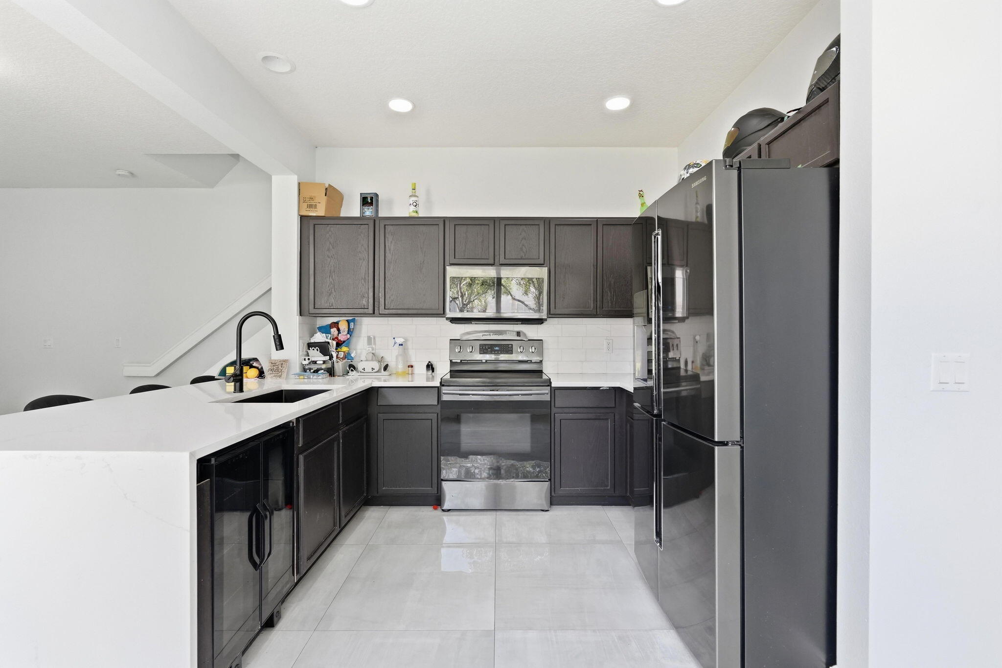 1086 Woodfield Road Greenacres, FL 33415 - Photo 9 of 32 a kitchen with stainless steel appliances granite countertop a refrigerator and a sink