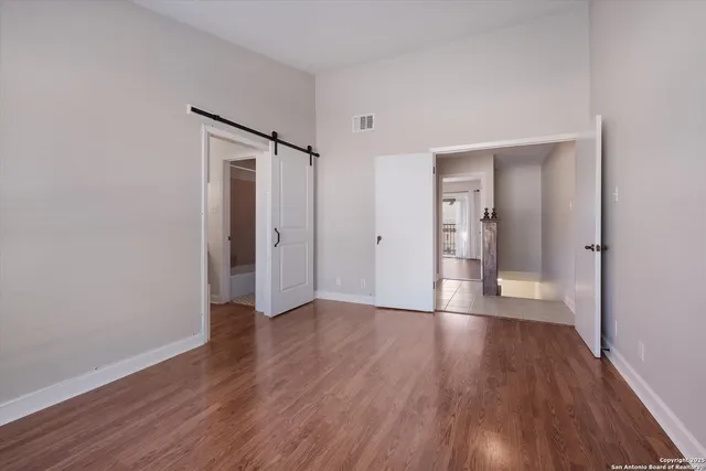 a bathroom with a granite countertop sink a toilet and a mirror