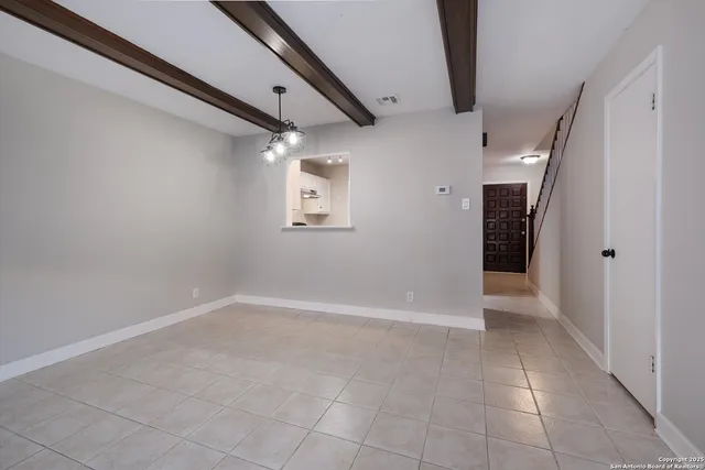 a view of an empty room with a bathroom
