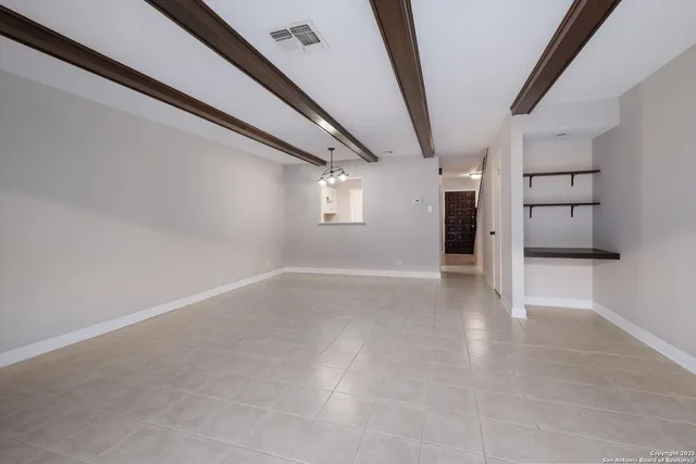 a kitchen with granite countertop a stove sink and cabinets