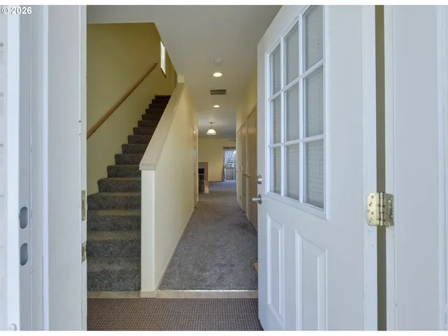 a view of entryway and hall with wooden floor