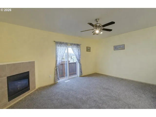 a view of an empty room with a ceiling fan