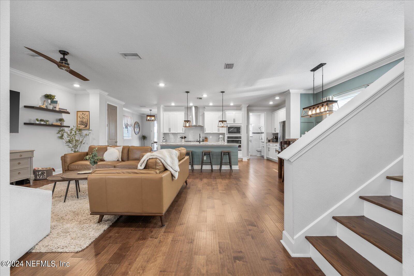 196 Ashbury Street St. Augustine, FL 32092 - Photo 13 of 35 a living room with furniture and a table with wooden floor