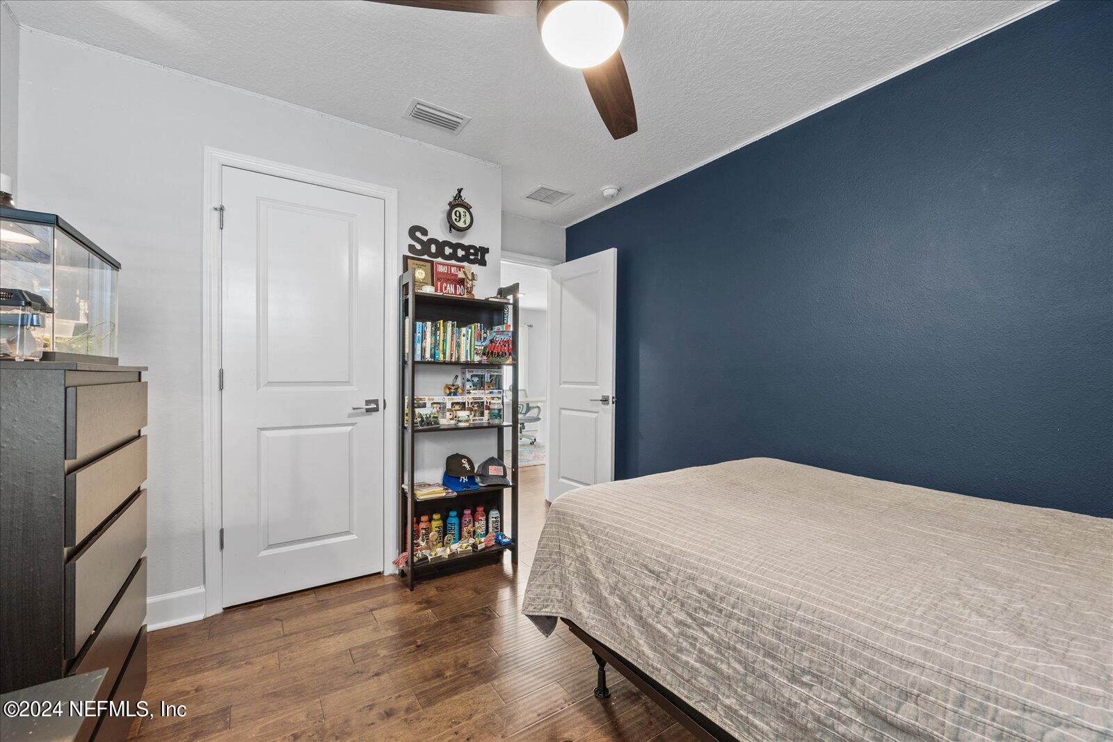 196 Ashbury Street St. Augustine, FL 32092 - Photo 17 of 35 a bedroom with a bed and a book shelf