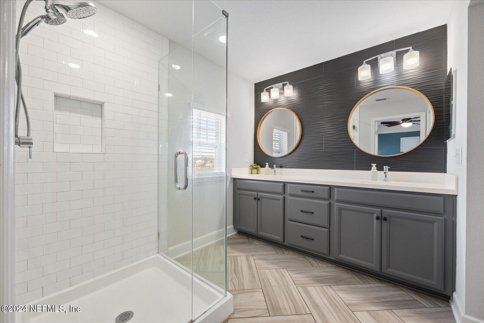 196 Ashbury Street St. Augustine, FL 32092 - Photo 19 of 35 a spacious bathroom with a double vanity sink and a mirror